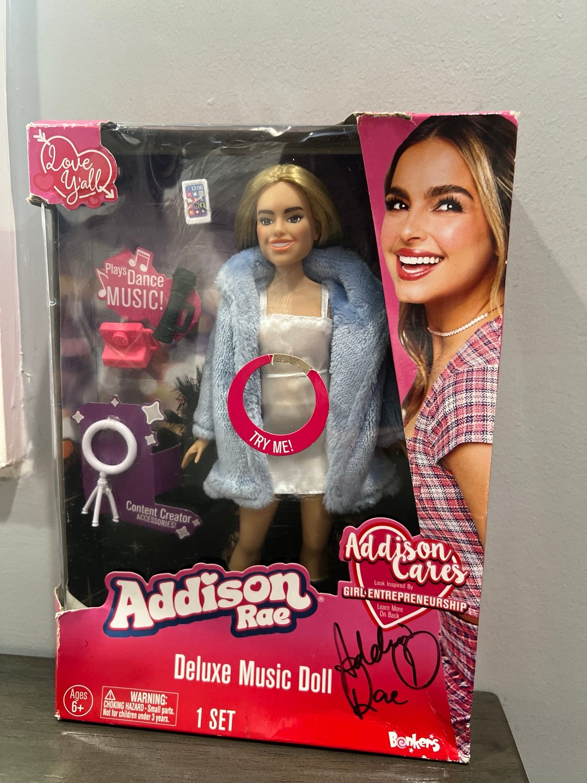 Signed deluxe Addison Rae Barbie Doll in damaged box.
