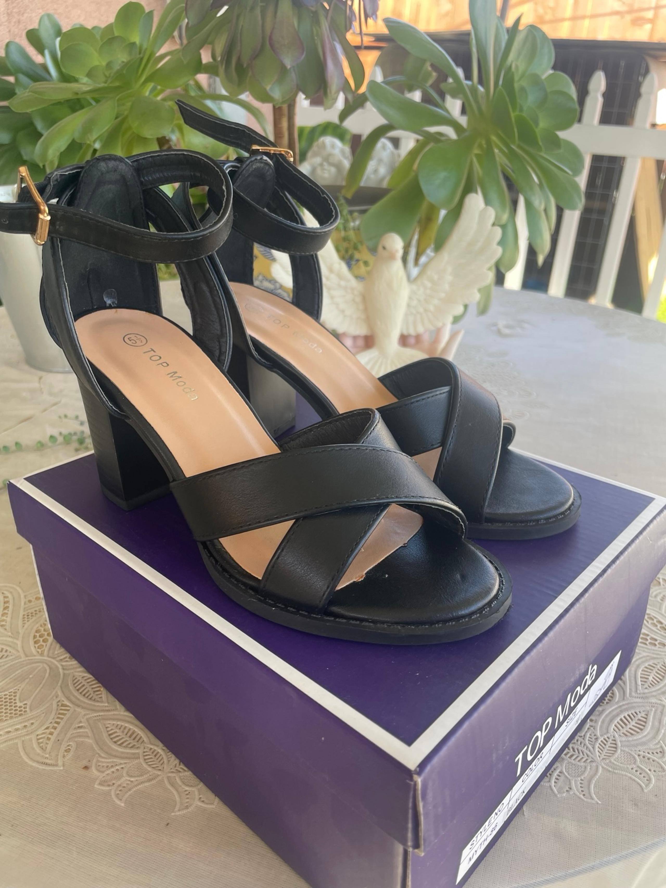 Black block heels with bronze buckle