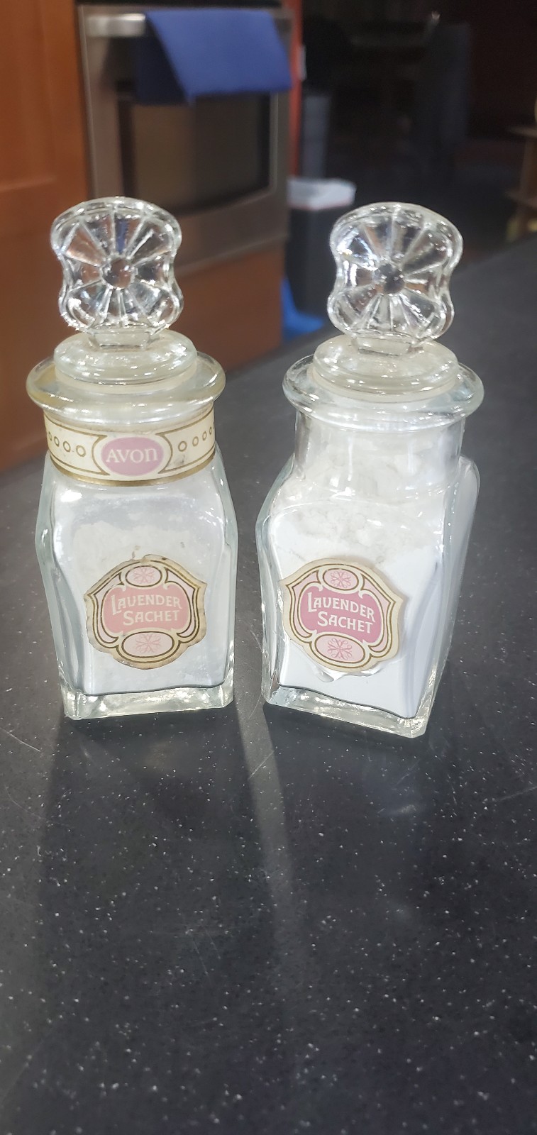 A Pair of Vintage AVON Lavender Sachet Glass Bottle With Ornate Stopper |