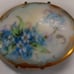 A antique porcelain hand-painted brooch