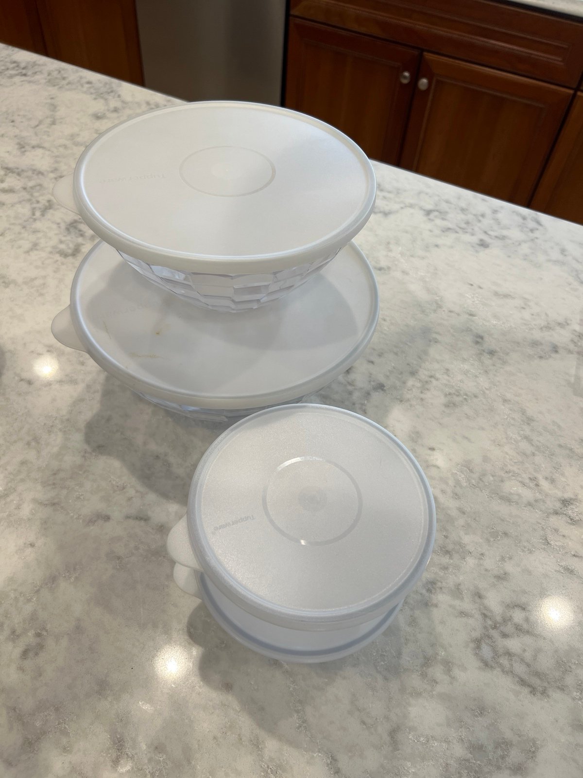 Tupperware set of four bowls with lids.