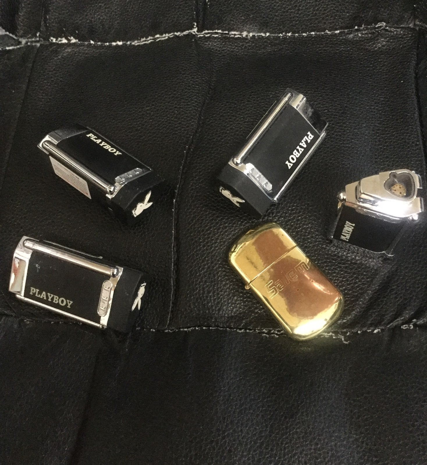Four PlayBoy lighter and one Salem