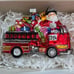 Santa Riding a Fire Truck full of Christmas Gifts Glass Ornament Neiman Marcus