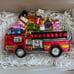 Santa Riding a Fire Truck full of Christmas Gifts Glass Ornament Neiman Marcus