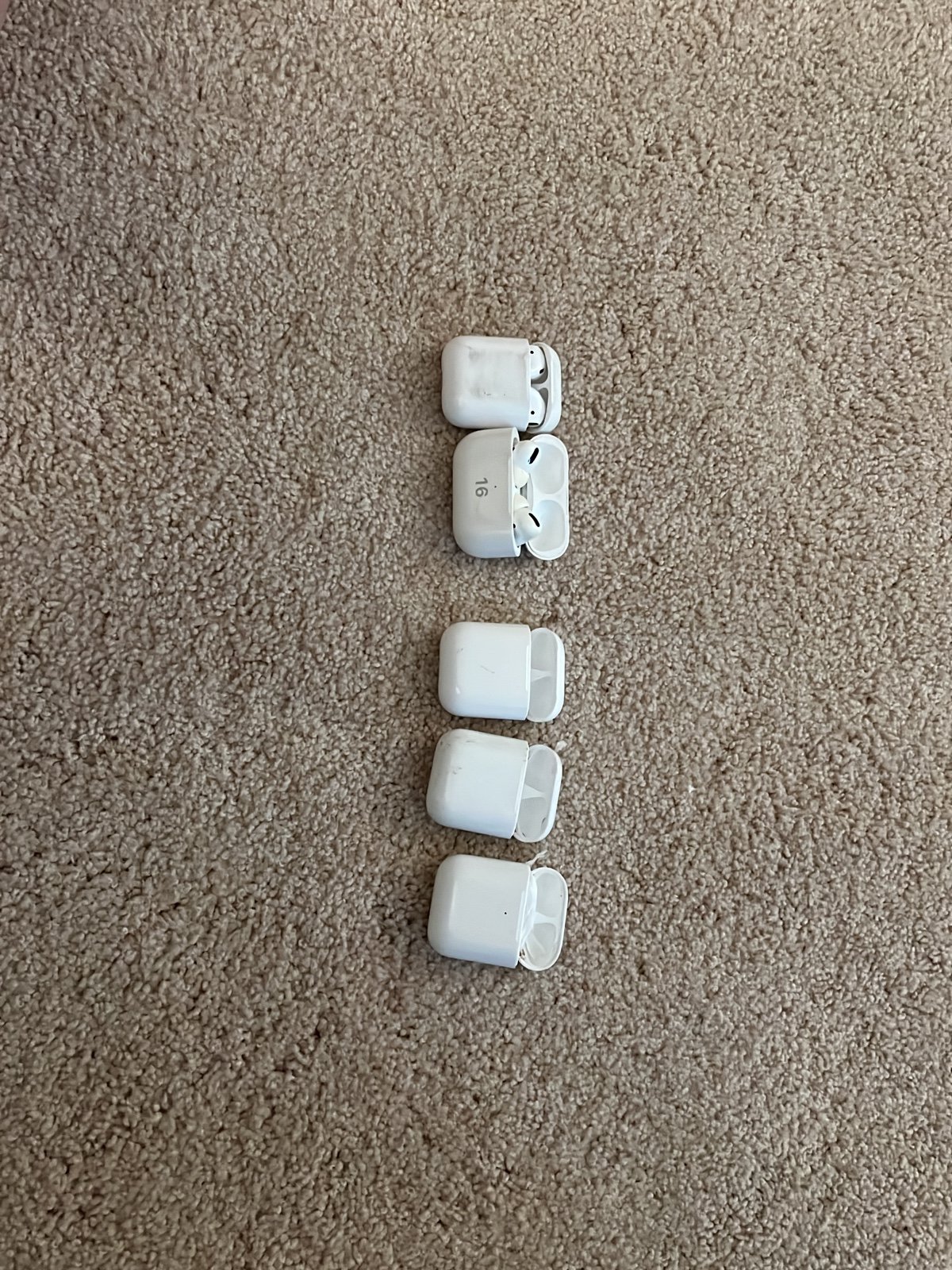 airpod pro with 16 on case, regular air pods, and three empty AirPod cases