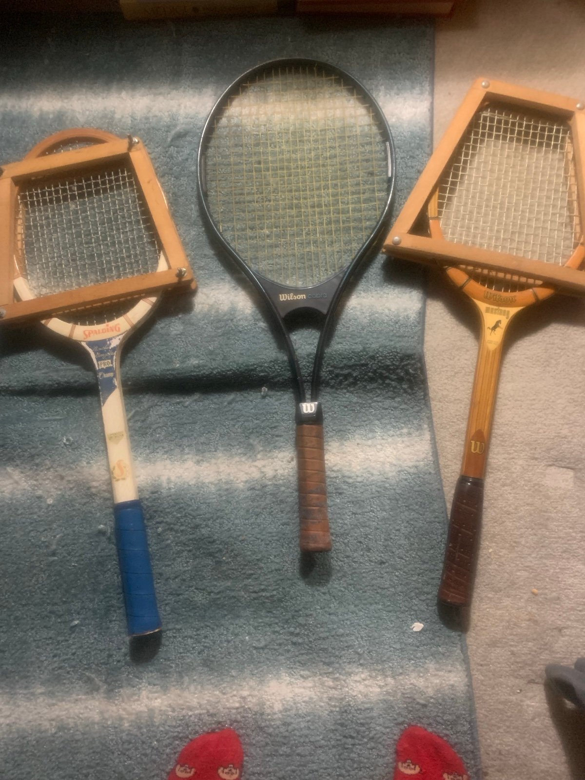 Three old tennis rackets