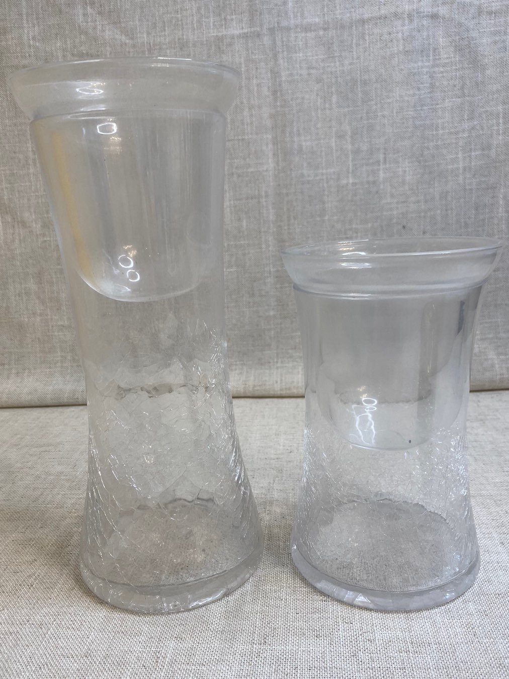 Two crackled clear glass candle holders.