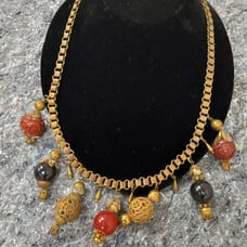 Antique 1920's brass charm necklace with carved Cinnabar brass and glass beads