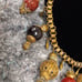 Antique 1920's brass charm necklace with carved Cinnabar brass and glass beads