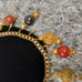 Antique 1920's brass charm necklace with carved Cinnabar brass and glass beads