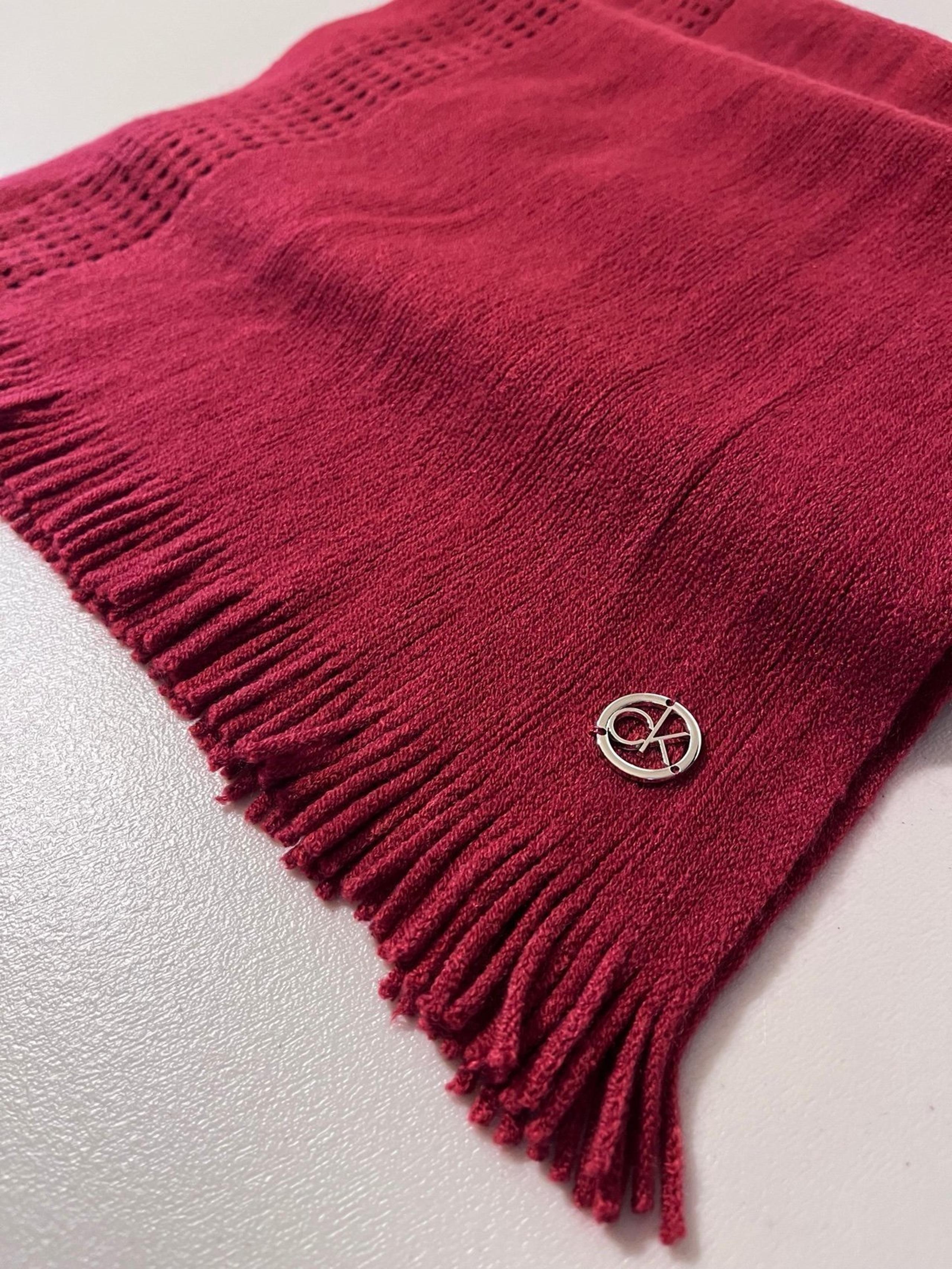 NWOT.  Calvin Klein burgundy knit scarf with 1” fringe.