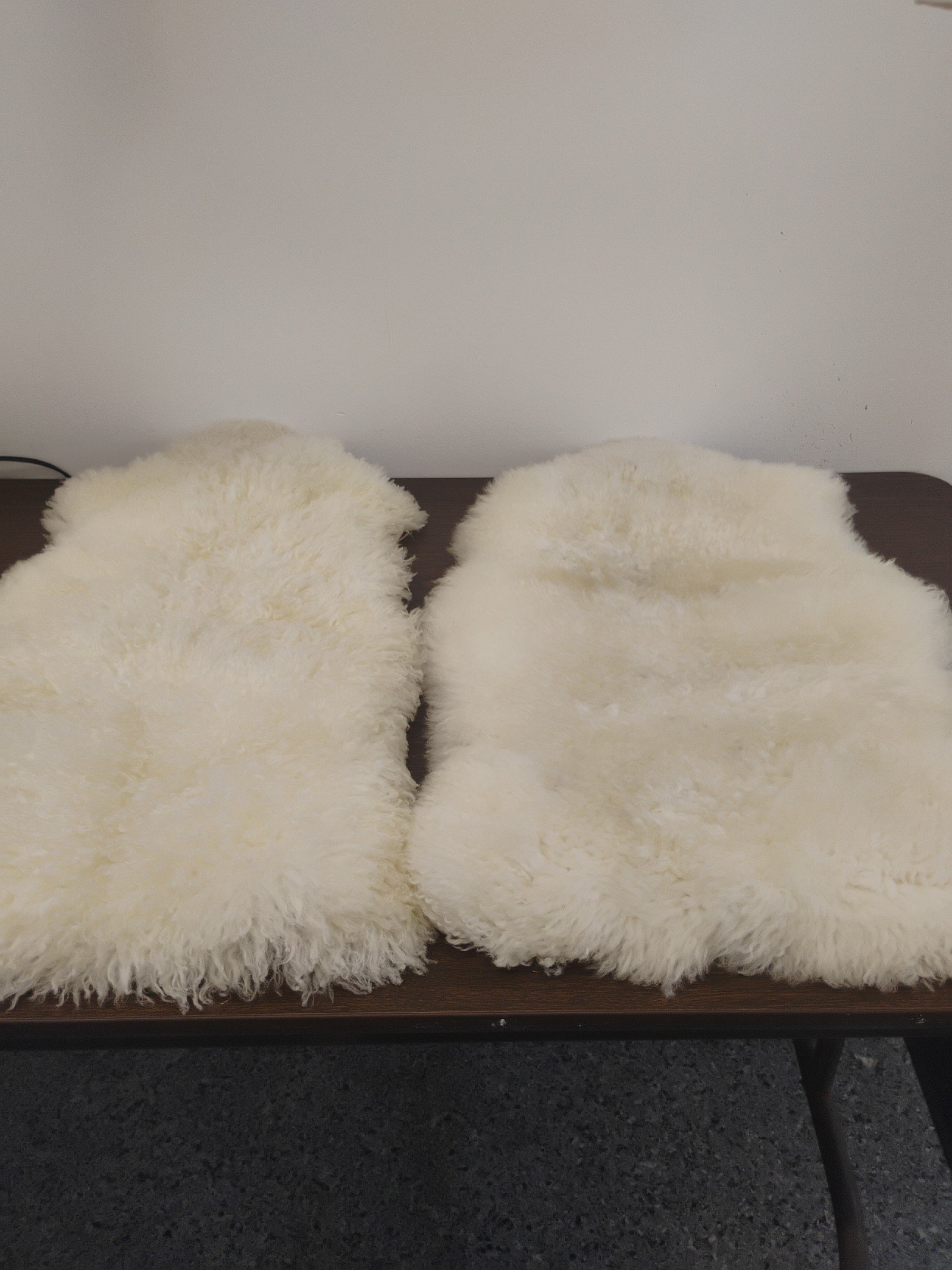 A pair of sheepskin throw rugs.