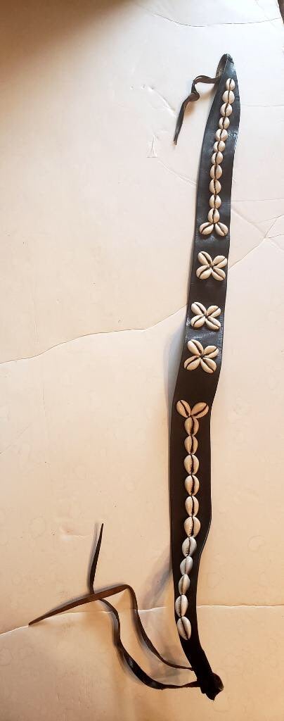 Cowrie shell flower design on black leat