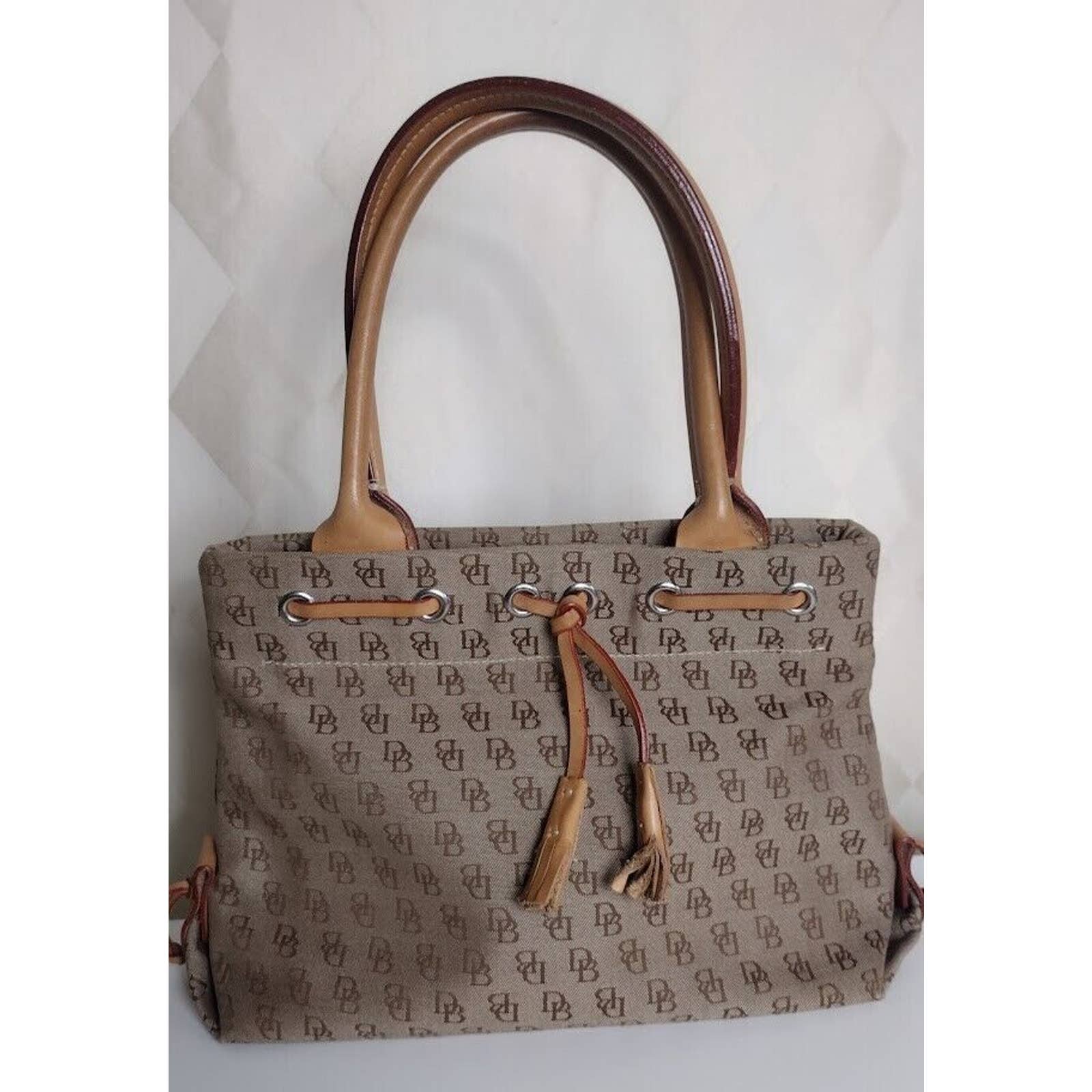 Dooney and Bourke Tan and Brown Canvas and Leather Bag with Tassel