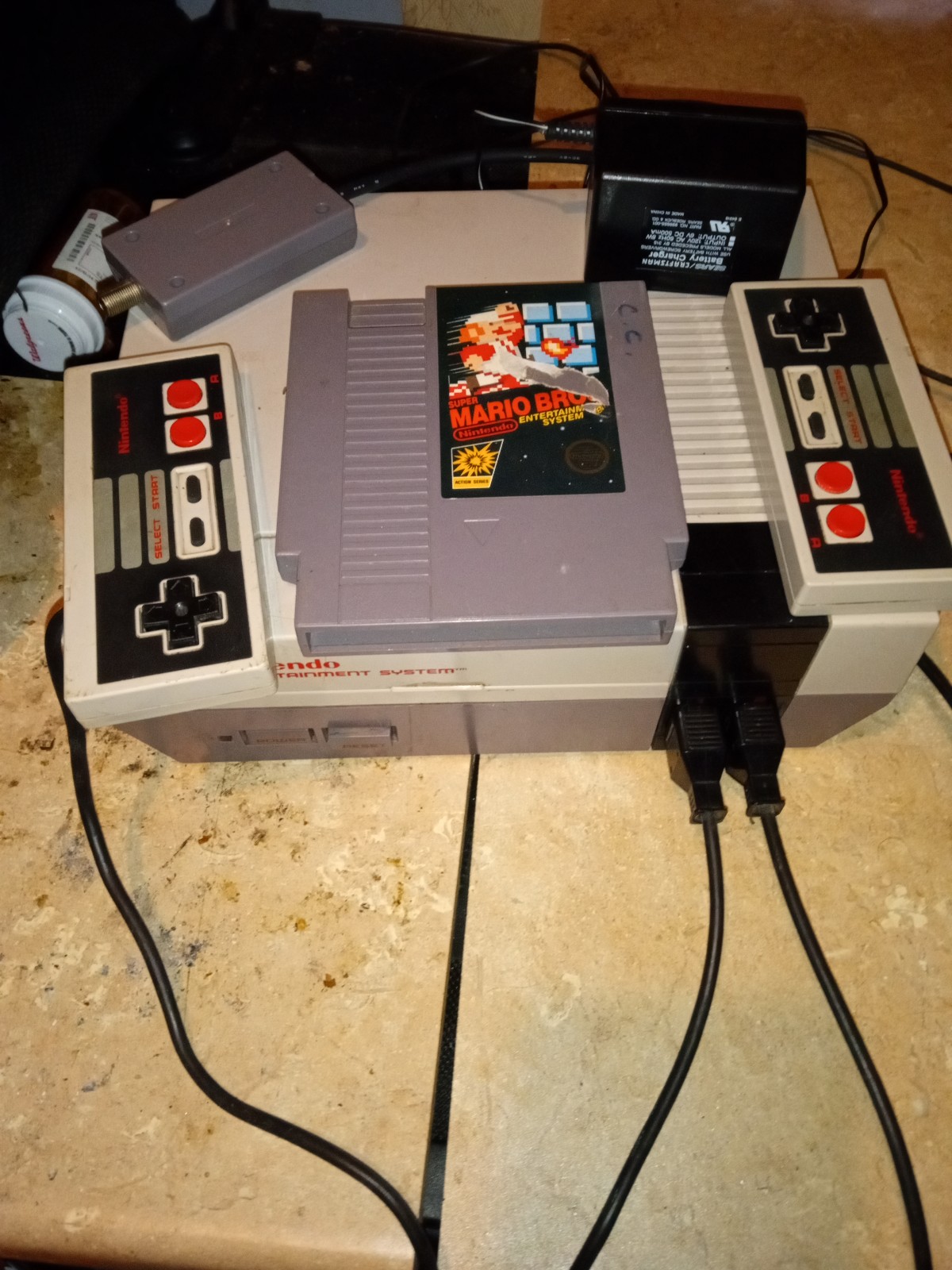 Nes with 2 controllers, hookups and super Mario bros.