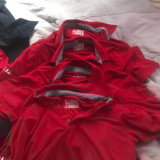 A red chick fil a polo
