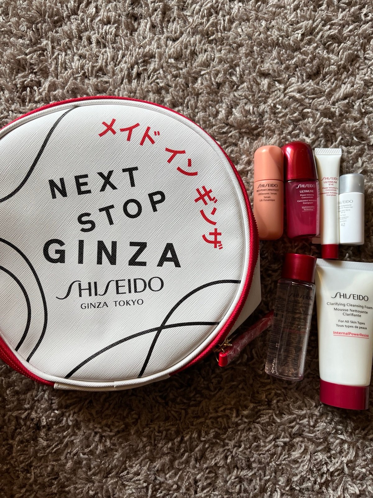 White round shiseido “Next stop Ginza” cosmetic bag with 6 products