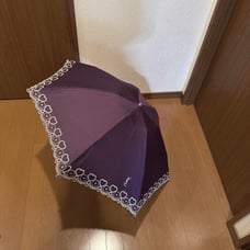 A Saint Laurent parasol with elegant purple and silver embroidery.