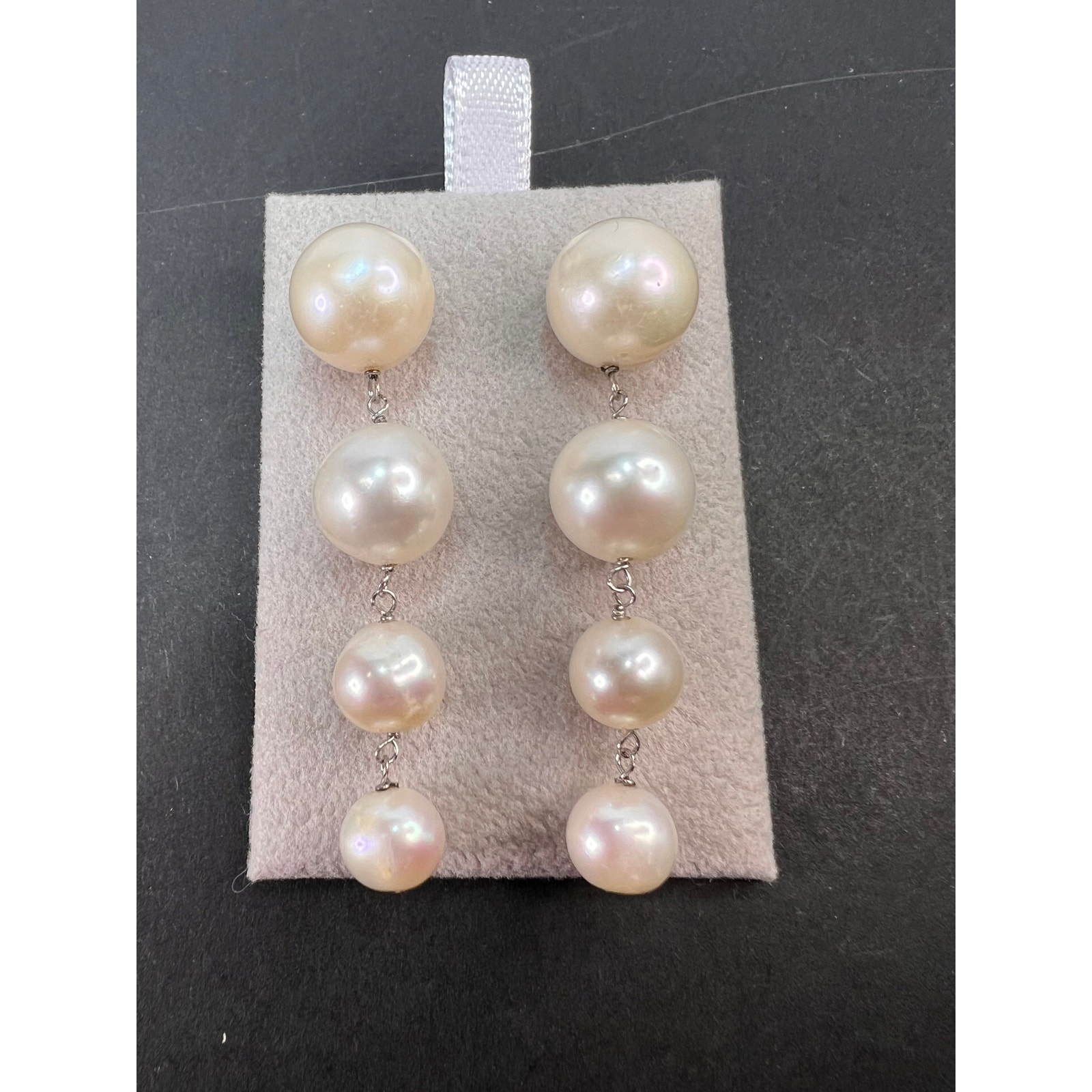 Graduated dangling pearl earrings in sterling silver