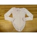 Intimately Free People long sleeve light pink Henley Sloan bodysuit.
