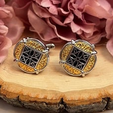 Elegant Gold and Black Cufflinks with Silver Fleury Cross