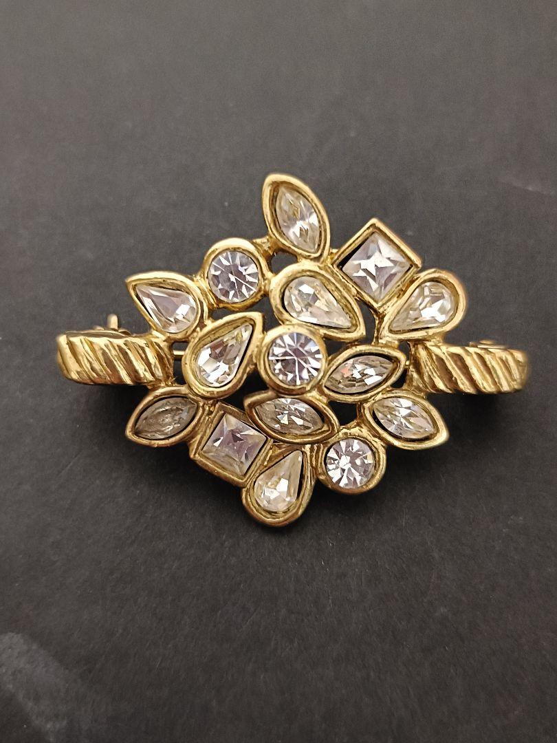 Yves Saint Laurent brooch, gold, stone, no accessories.