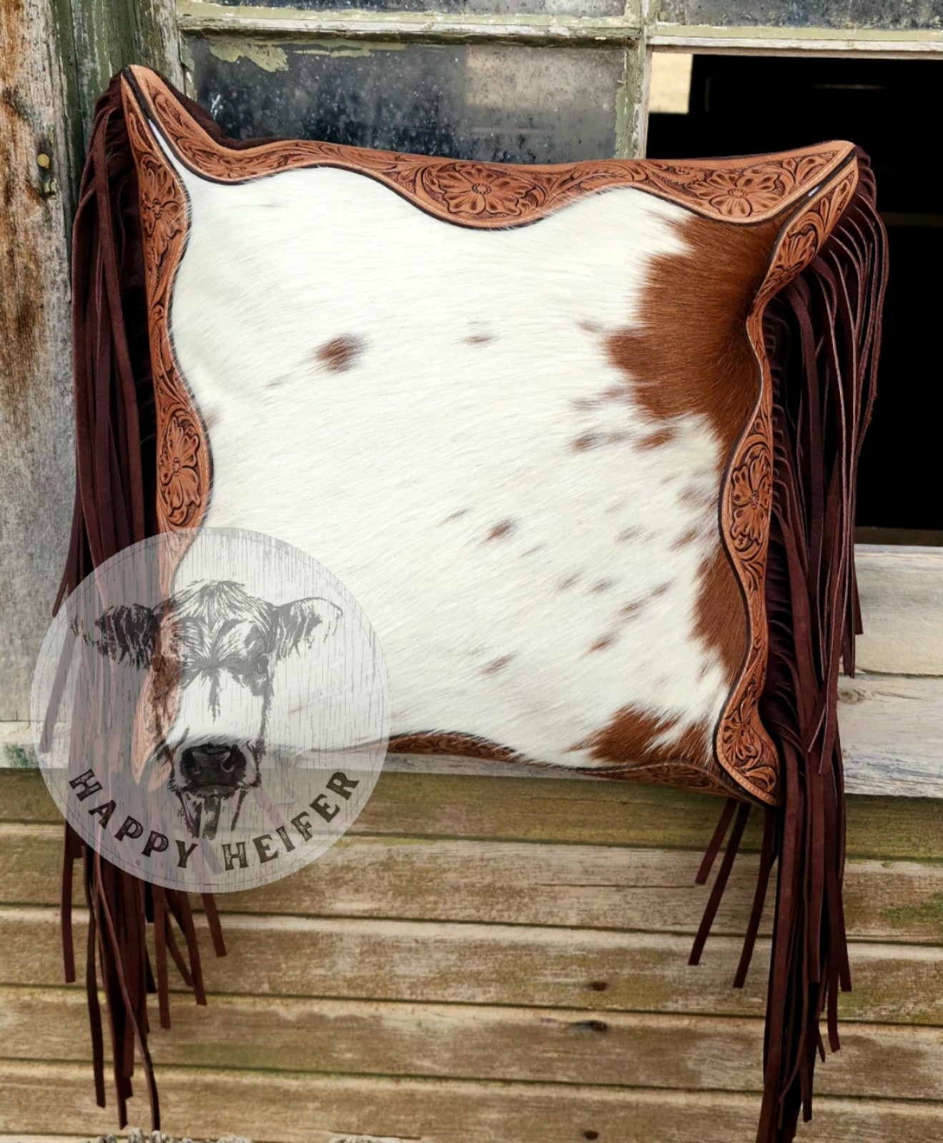 Stylish cowhide pillow with intricate leather trim. NWT
