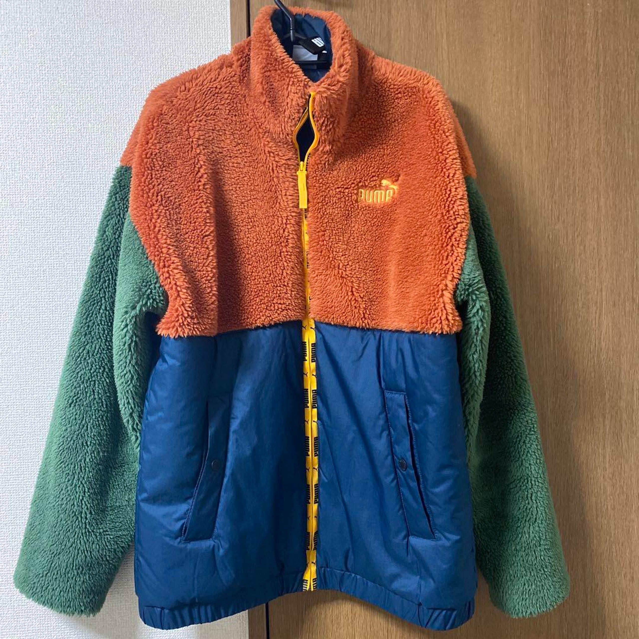 PUMA fleece jacket size M in orange, green, and navy.