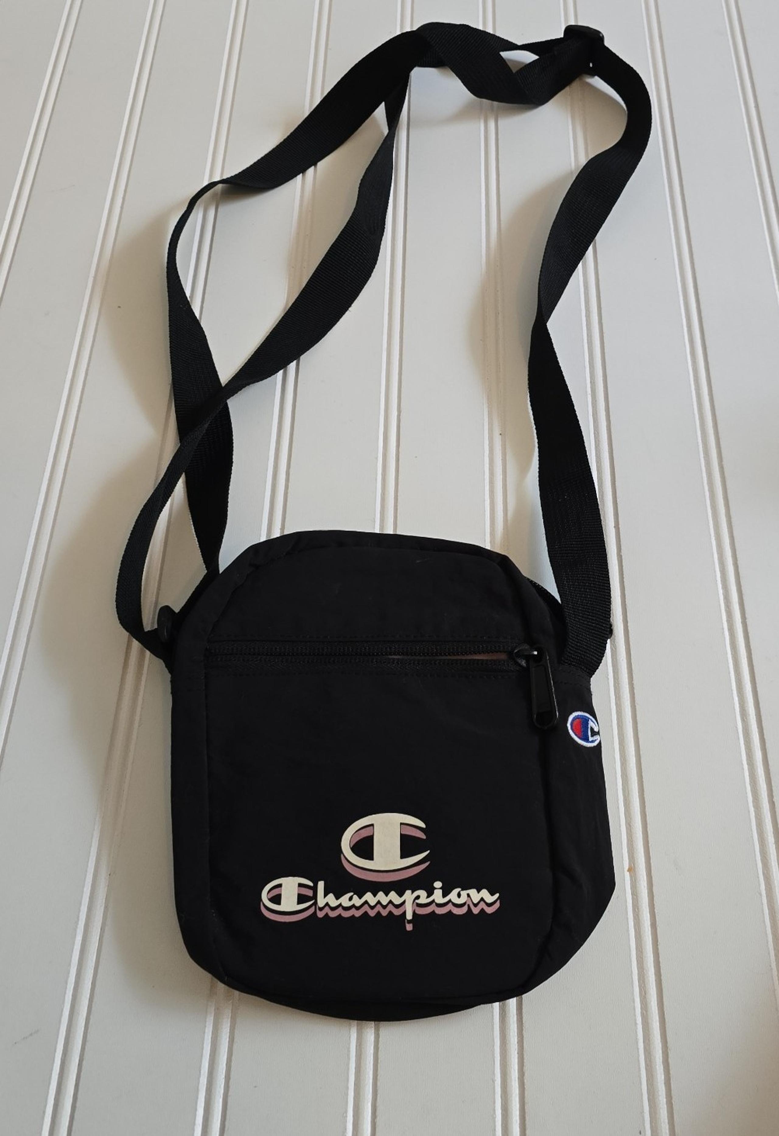 Champion crossbody mini bag ,adjustable Good condition pocket front  black light