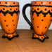 Rare Rae Dunn M Magenta set of 2 footed orange black polka dot mugs footed. Ve
