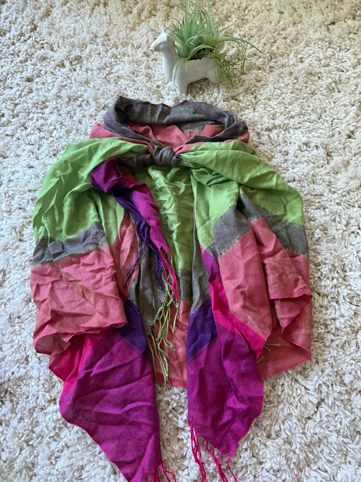 Bright scarf featuring pink, green, and purple hues