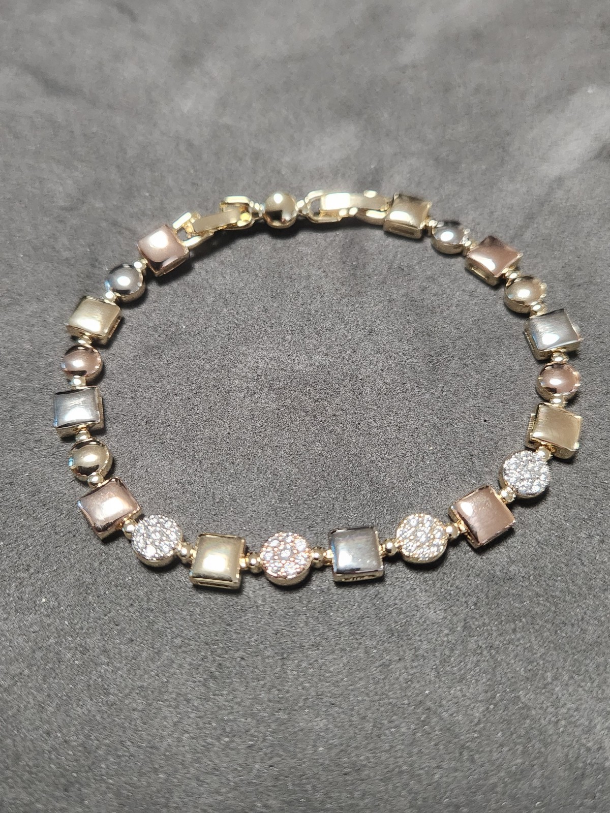 Beautiful elegant tri - color bracelet with four white stones and daul clamps