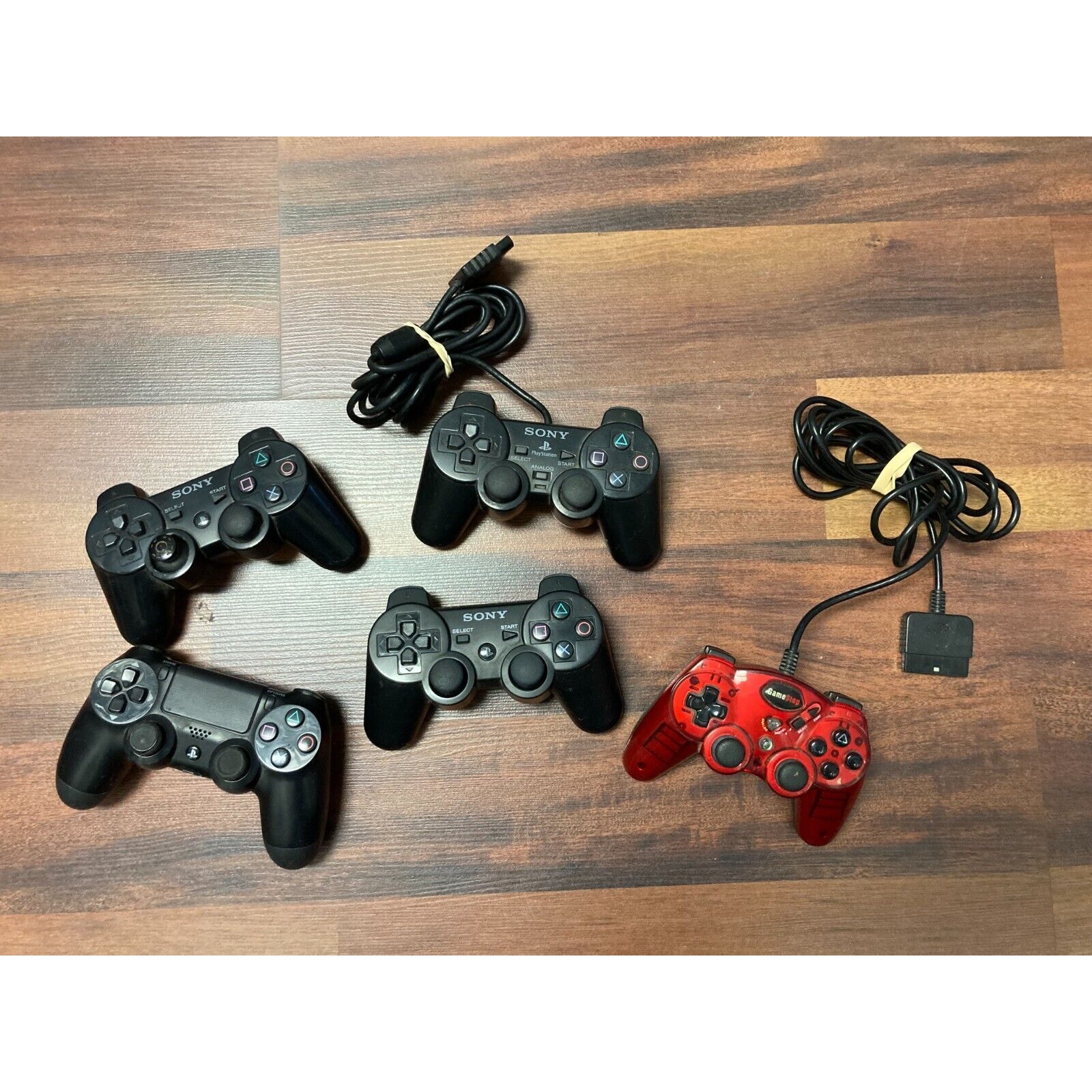 LOT of 4 Sony Playstation Controllers & 1 Game Stop - SOLD AS IS