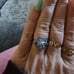 10k white gold ring with blue topaz and multi gems.
