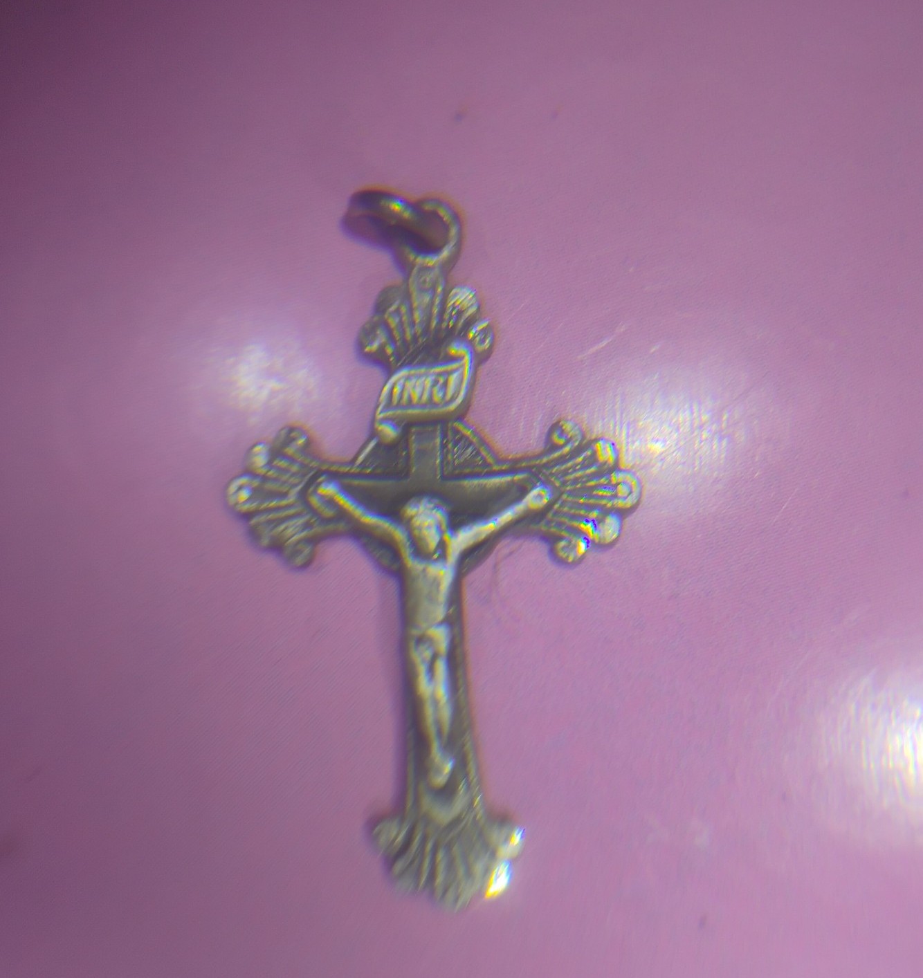 Sterling silver cross with Jesus on it.