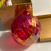Glass luminescent red Christmas ball ornament by Glass Eye Studio in Candy Red