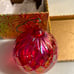 Glass luminescent red Christmas ball ornament by Glass Eye Studio in Candy Red