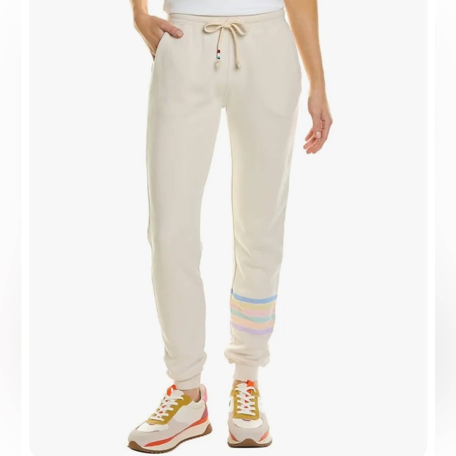 Sol Angeles cream with pastel striped sweatpants
