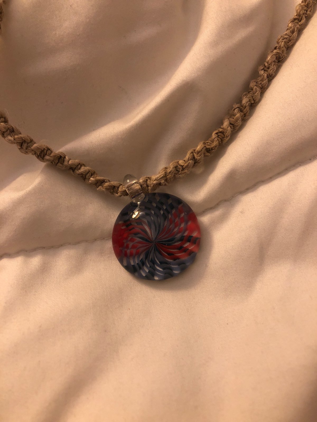 Hand blown glass pendant on hemp cord