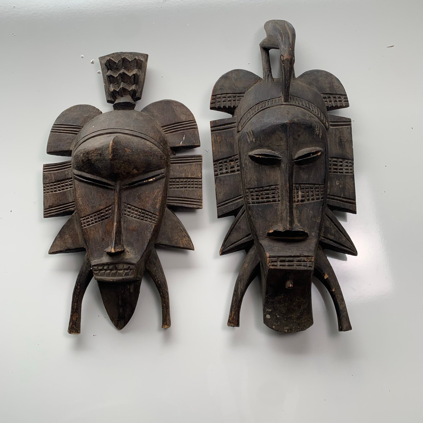 Lot of 2 Hand carved Kpelle wooden mask of the Senufo people with Hornbill