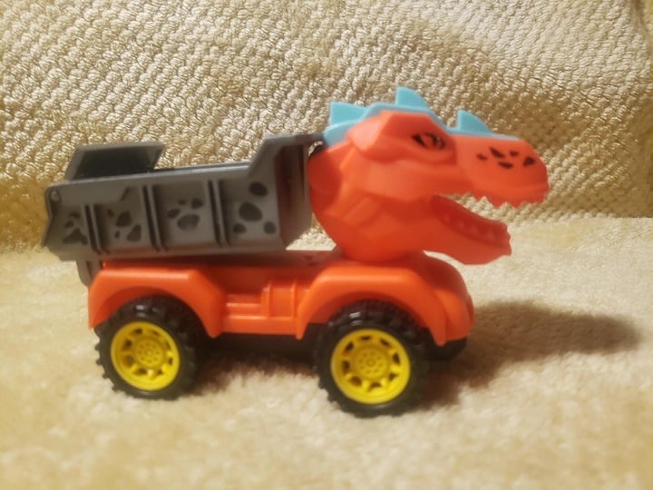 Orange Plastic Monster Dump Truck toy 5 inches long 2 inches tall
