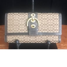 Coach wallet, tan and brown in color, gold tone hardware good condition. Measure