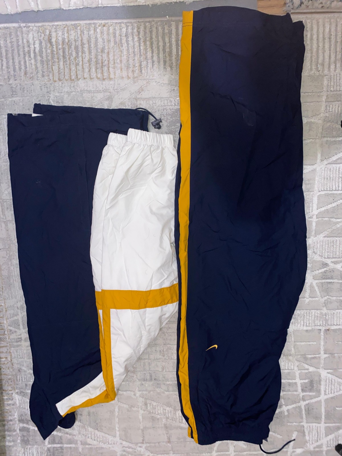 Dark blue and white sweatpants and jacket with yellow accents