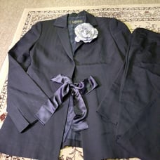 LANVIN black pantsuit with a ribbon and flower embellishment.
