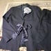 LANVIN black pantsuit with a ribbon and flower embellishment.