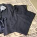 LANVIN black pantsuit with a ribbon and flower embellishment.