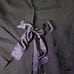 LANVIN black pantsuit with a ribbon and flower embellishment.
