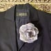 LANVIN black pantsuit with a ribbon and flower embellishment.