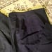 LANVIN black pantsuit with a ribbon and flower embellishment.
